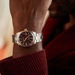 Load image into Gallery viewer, Bulova Surveyor automatic watch with rose gold case and red dial, showcasing a sleek, stylish timepiece with a modern design.