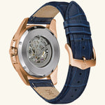 Load image into Gallery viewer, Bulova Sutton Classic watch with a rose gold dial and blue strap, showcasing elegant timepiece design.