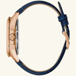 Load image into Gallery viewer, Bulova Sutton Classic watch with rose gold dial and blue strap, showcasing elegant design and stylish accessories.