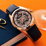 Load image into Gallery viewer, Bulova Sutton Classic watch with rose gold dial and blue strap, showcasing elegant design and polished finish.